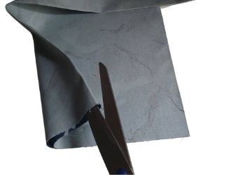 scissor blades cutting fabric on the fold