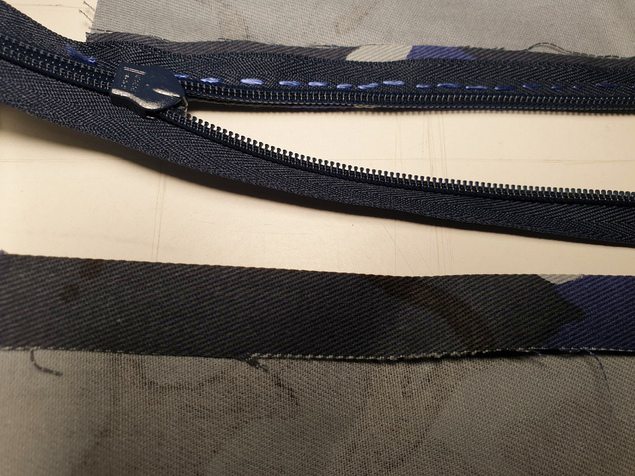 back view of one zipper arm sewn in place