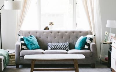 grey sofa and walls, teal accent scatter cushions