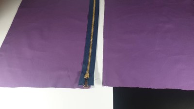 zip placed over edge of one panel of fabric